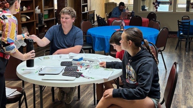 A teacher shares information about budgeting with Southeast Colorado students.